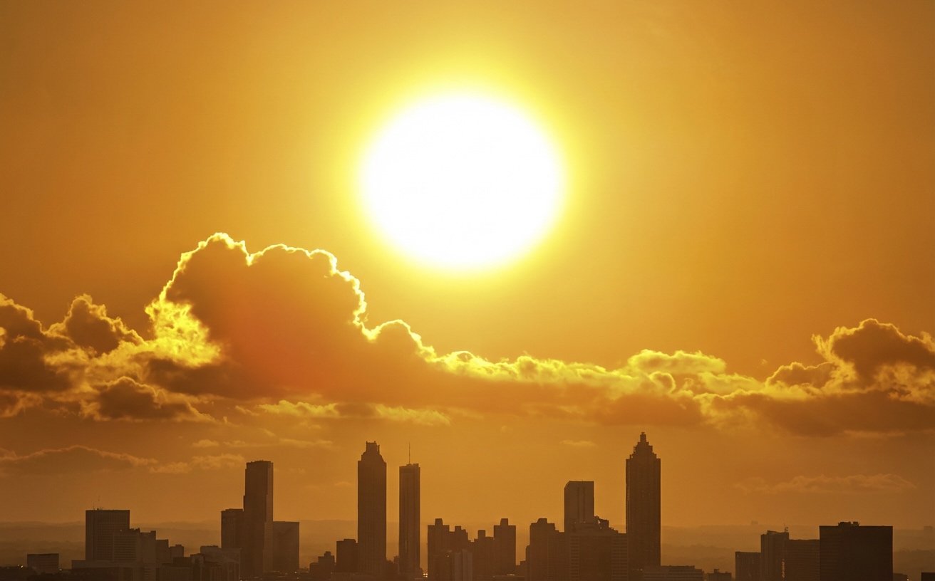 Bright summer sun and clouds over Atlanta sky, heat affecting fridge cooling in hot climate