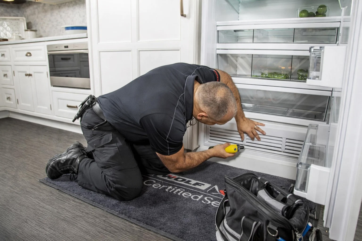 The technician handles Refrigerator problems